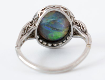 Lot 54 - A black opal and diamond cluster ring.