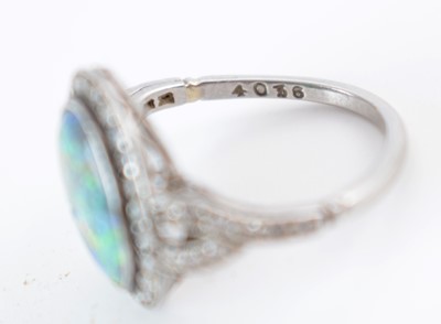 Lot 54 - A black opal and diamond cluster ring.
