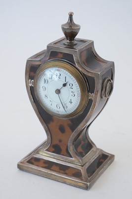 Lot 764 - An Edwardian silver and tortoiseshell mantel timepiece.