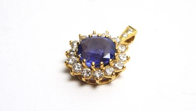 Lot 27 - A sapphire and diamond cluster pendant