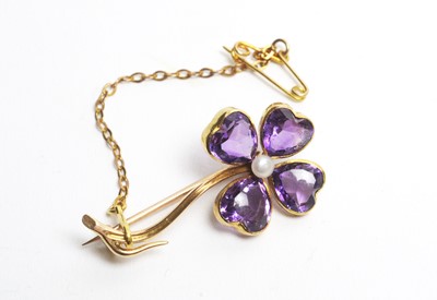 Lot 35 - An amethyst and pearl flower pattern brooch