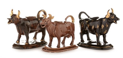 Lot 510 - Three 19th century cow creamers