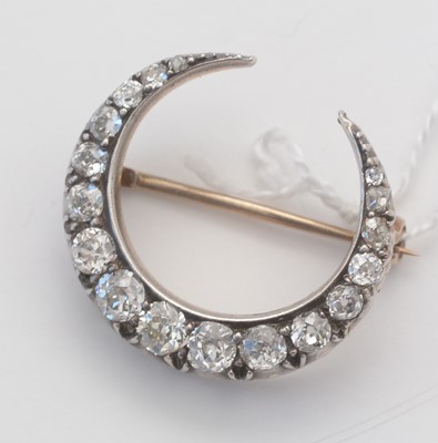 Lot 1 - A diamond crescent brooch.