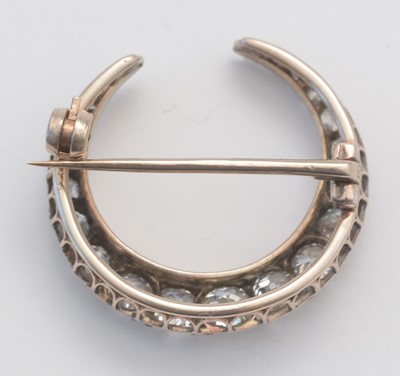 Lot 1 - A diamond crescent brooch.