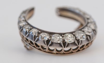 Lot 1 - A diamond crescent brooch.