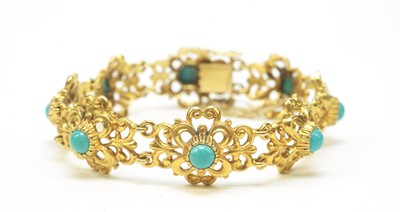 Lot 84 - A turquoise set 9ct yellow gold bangle