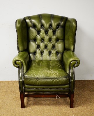 Lot 75 - A 20th Century wingback armchair