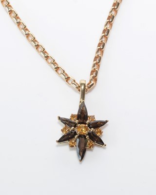Lot 222 - A smokey quartz and citrine pendant.