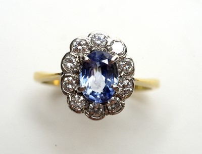 Lot 101 - A sapphire and diamond cluster ring