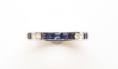 Lot 2 - A diamond and sapphire eternity ring