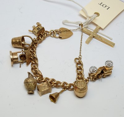 Lot 155 - A 9ct gold charm bracelet and gold charms, and a 9ct gold cruciform pendant.