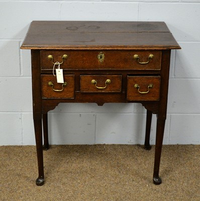 Lot 51 - An early 19th Century oak lowboy.