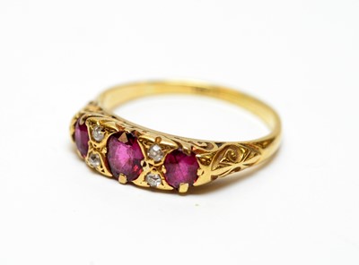 Lot 20 - A three-stone ruby and diamond dress ring.