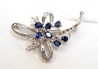 Lot 128 - A high-carat white metal, diamond, and sapphire brooch.