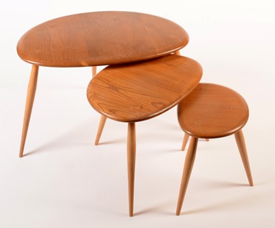 Lot 55 - Ercol: a light elm and beech nest of three tables.