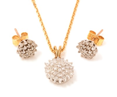 Lot 117 - A diamond cluster pendant and earrings
