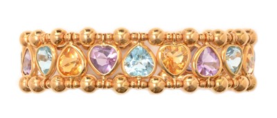 Lot 122 - A topaz, citrine and amethyst bangle