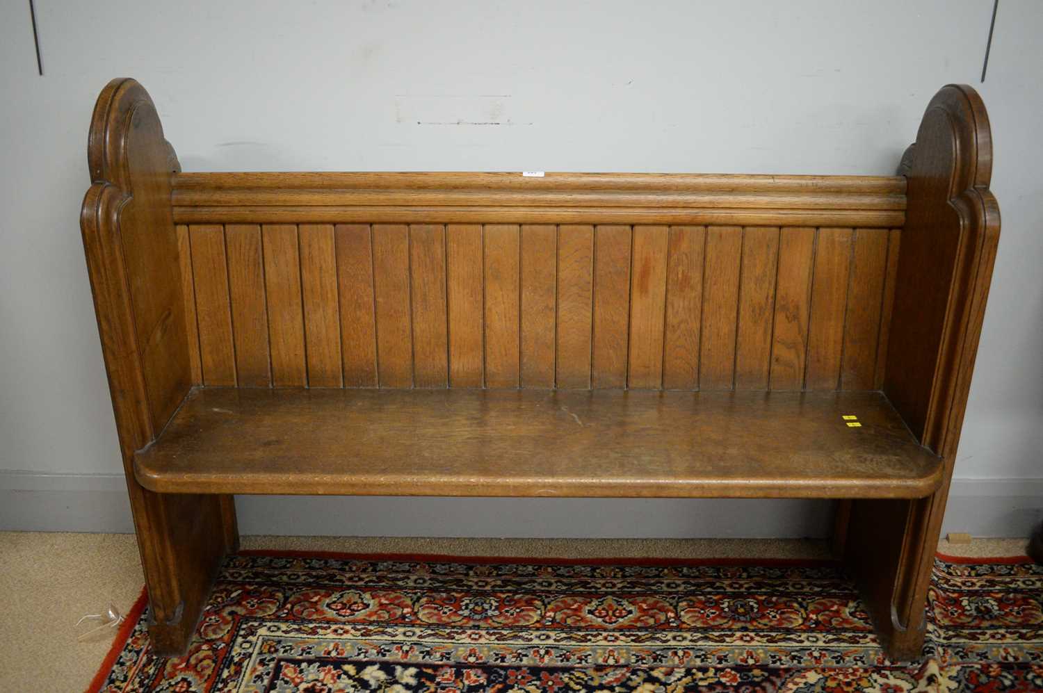 Lot 243 - An oak pew