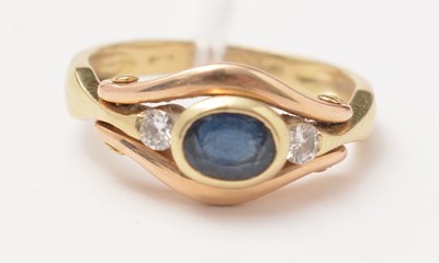 Lot 103 - A modern diamond and sapphire three-stone ring.