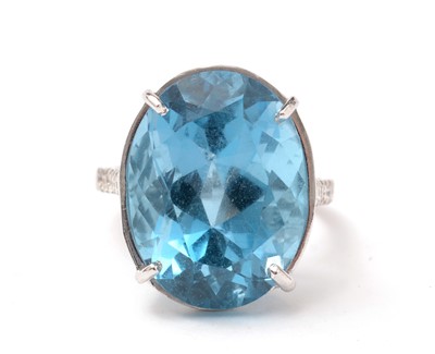 Lot 114 - A topaz and diamond dress ring.