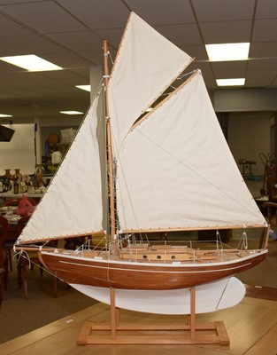Lot 468 - A 20th Century stained and white painted wood scale pond yacht