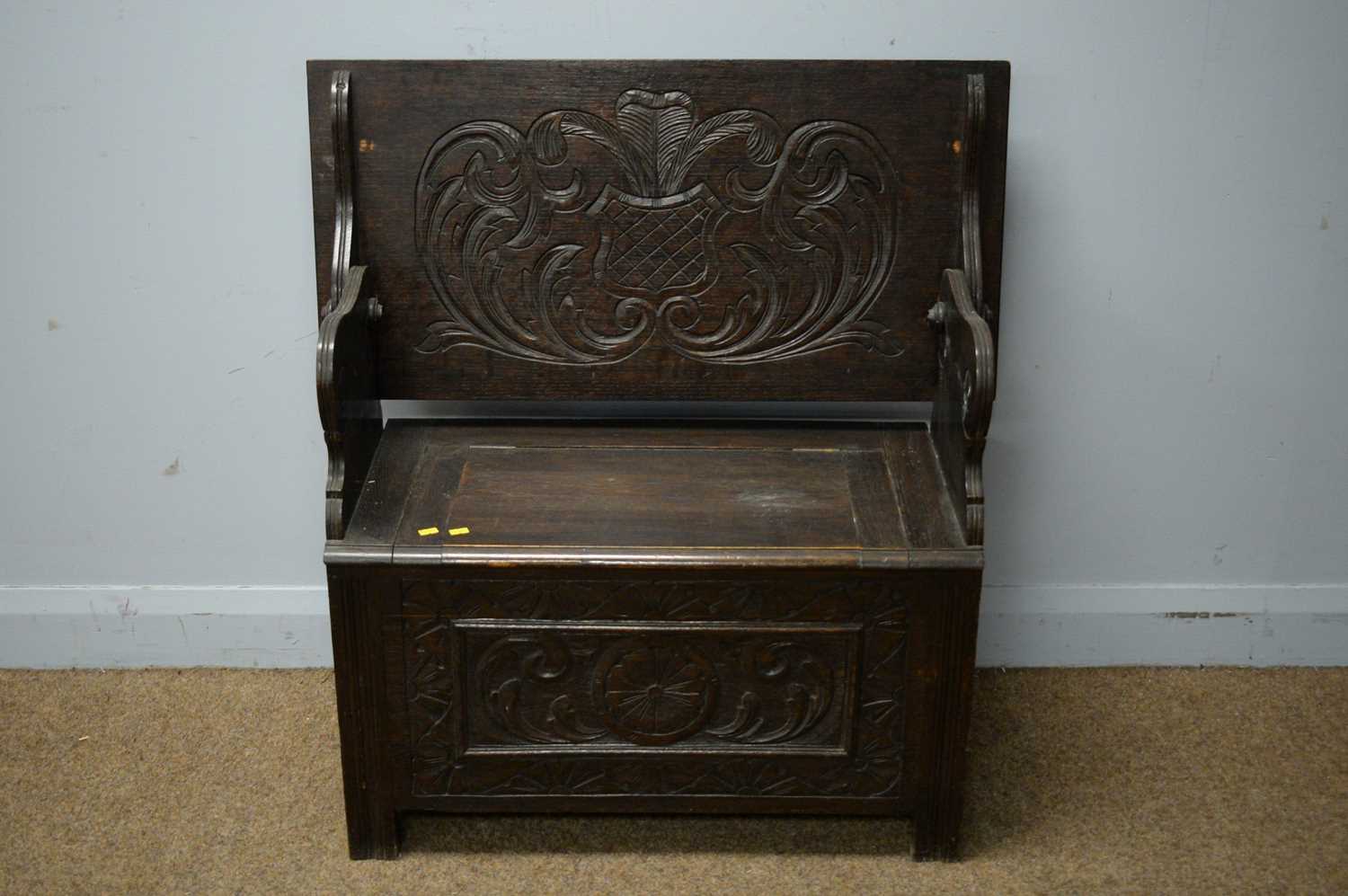 Lot 213 - A carved oak monk's bench