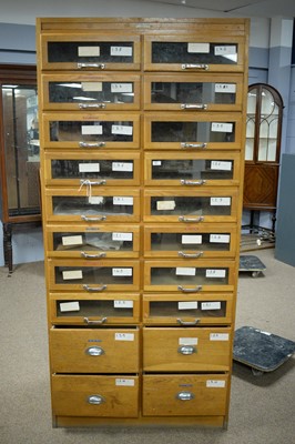 Lot 83 - A vintage light oak haberdashers cabinet