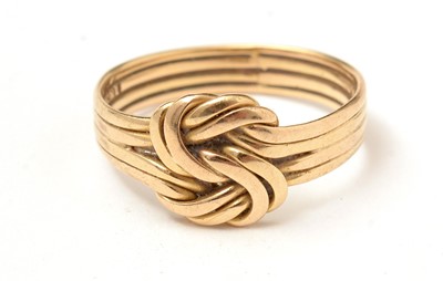 Lot 85 - A yellow-metal knot ring.