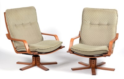 Lot 664A - Pair of laminated beechwood swivel armchairs.