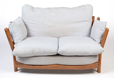 Lot 412 - Attributed to Ercol: a modern beech wood two-seater sofa.