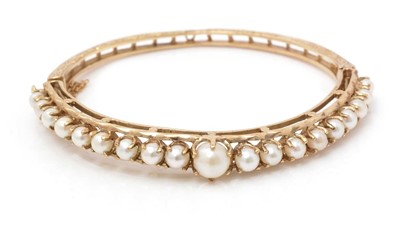 Lot 82 - Victorian style cultured pearl 9ct. yellow gold bangle.