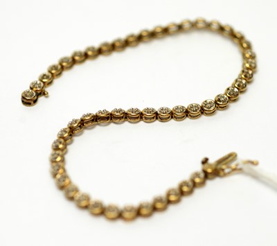 Lot 164 - A 9ct gold and diamond set tennis bracelet
