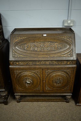 Lot 76 - A mid-20th Century carved oak writing bureau.