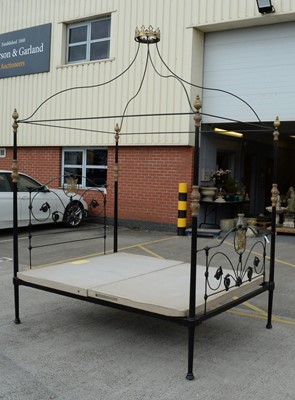 Lot 18 - An ornate wrought metal four poster bed