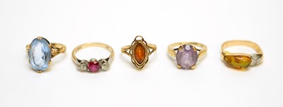 Lot 203 - An amber and diamond dress ring, and four others