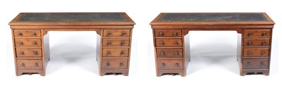 Lot 1052 - A near matching pair of mahogany pedestal writing desks.