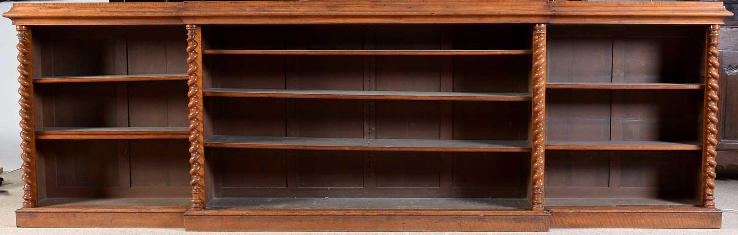 Lot 1091 - A large late Victorian walnut breakfront open bookcase