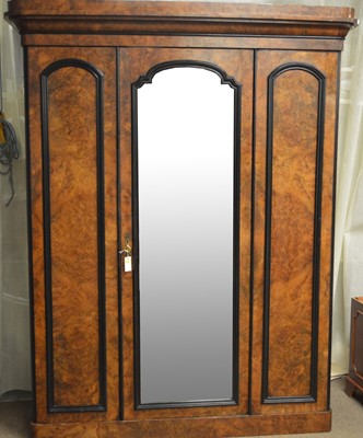 Lot 89 - A Victorian burr walnut and ebonised three door wardrobe.