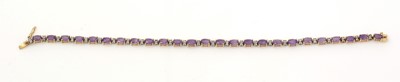 Lot 476 - A diamond and amethyst line bracelet