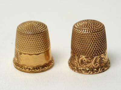 Lot 302 - Two yellow metal thimbles.