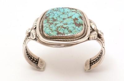 Lot 880 - Mary S. Lew, Navajo, Native American: a silver and rough turquoise bangle