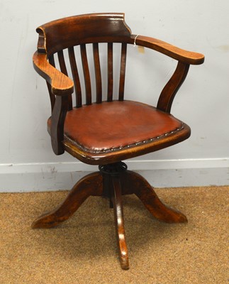 Lot 19 - An early 20th Century stained beech swivel office armchair