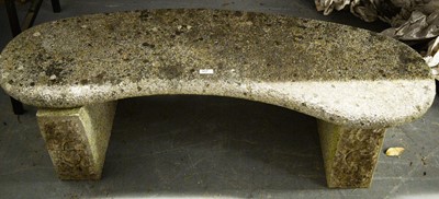 Lot 577 - A stone composite garden bench.
