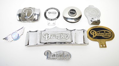 Lot 820 - A selection of Daimler cast metal car badges.