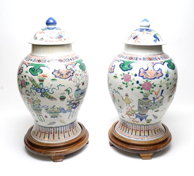 Lot 717 - Pair Chinese Famille Rose vases and covers