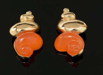 Lot 850 - Christian Dior: a pair of gilt-metal and orange plastic shell pattern clip earrings