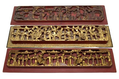 Lot 747 - Three Chinese red and gilt carved wood panels