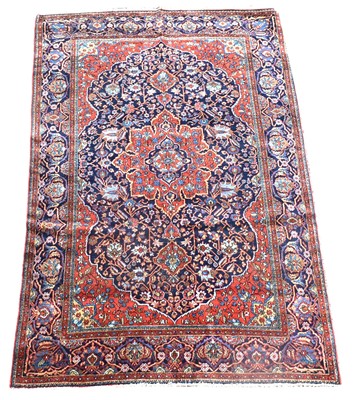 Lot 702 - An antique Kashan rug