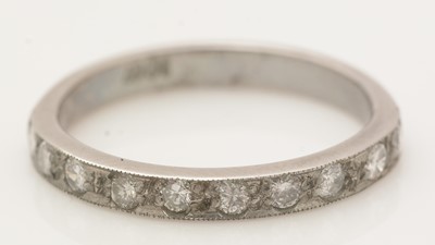 Lot 390 - A ten stone diamond half-hoop eternity ring