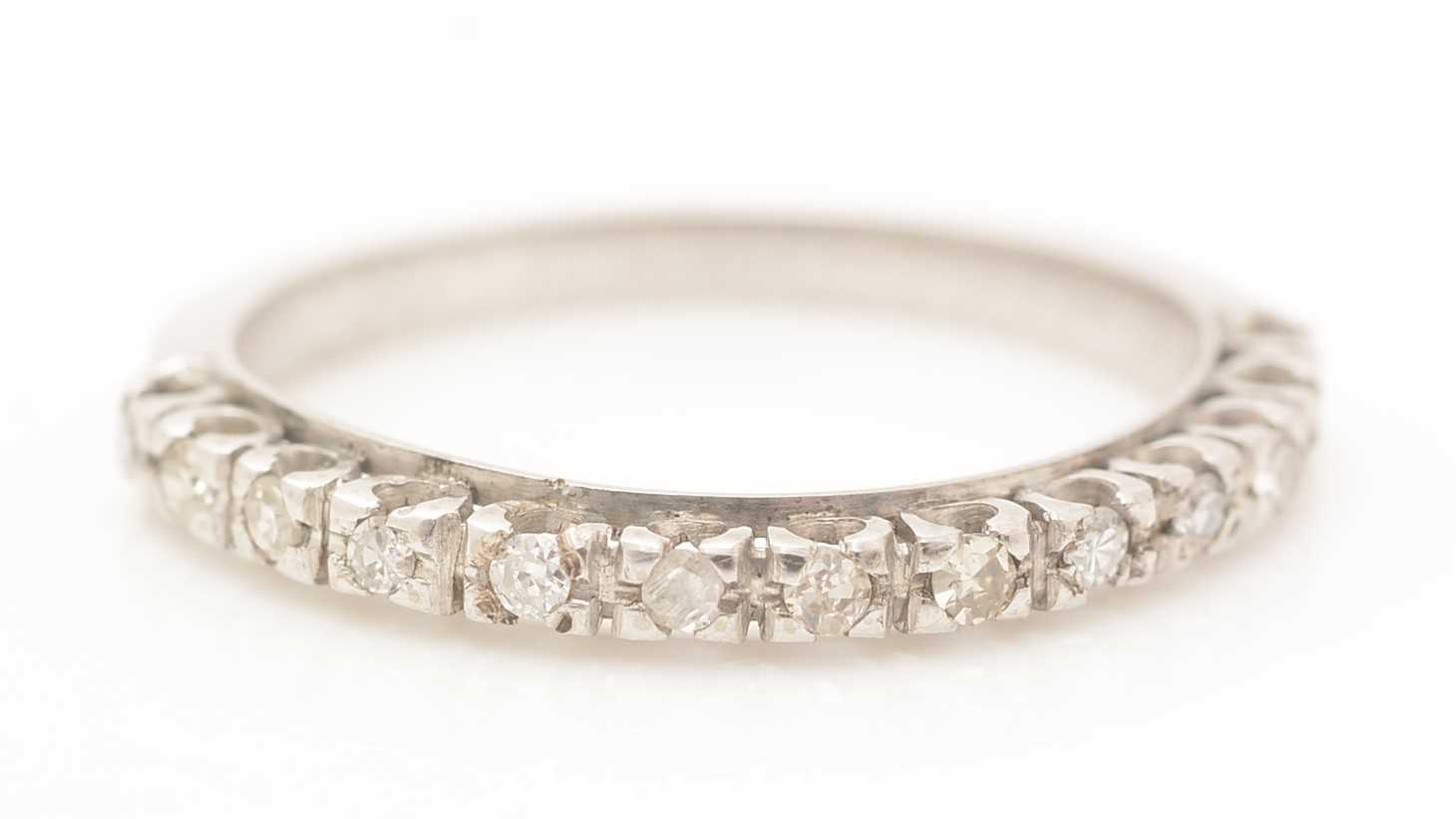 Lot 394 - A diamond half hoop eternity ring